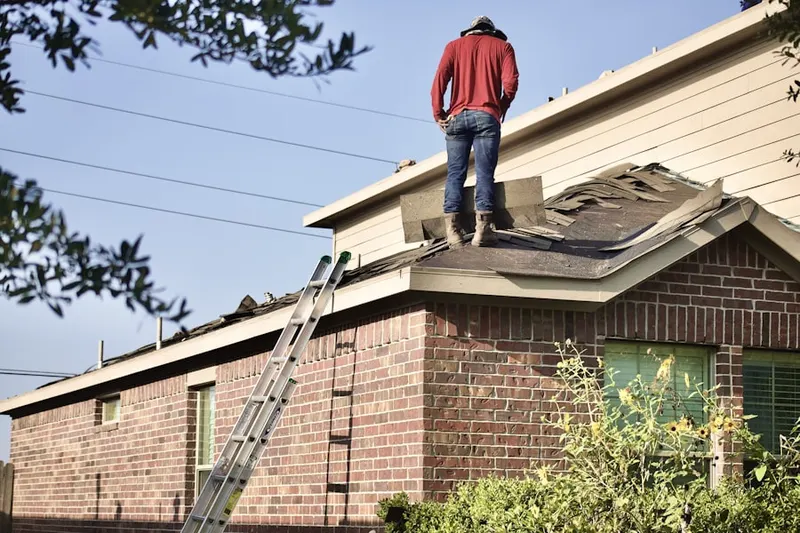 Professional roofer working on a residential roof in Bear Valley